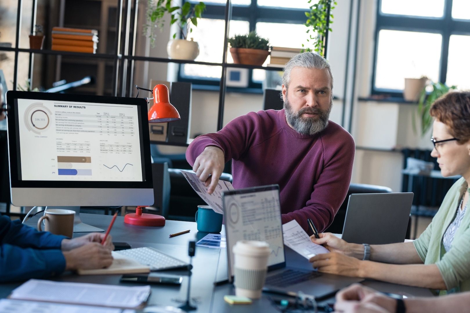 An author and an editor reviewing printed pages at a table