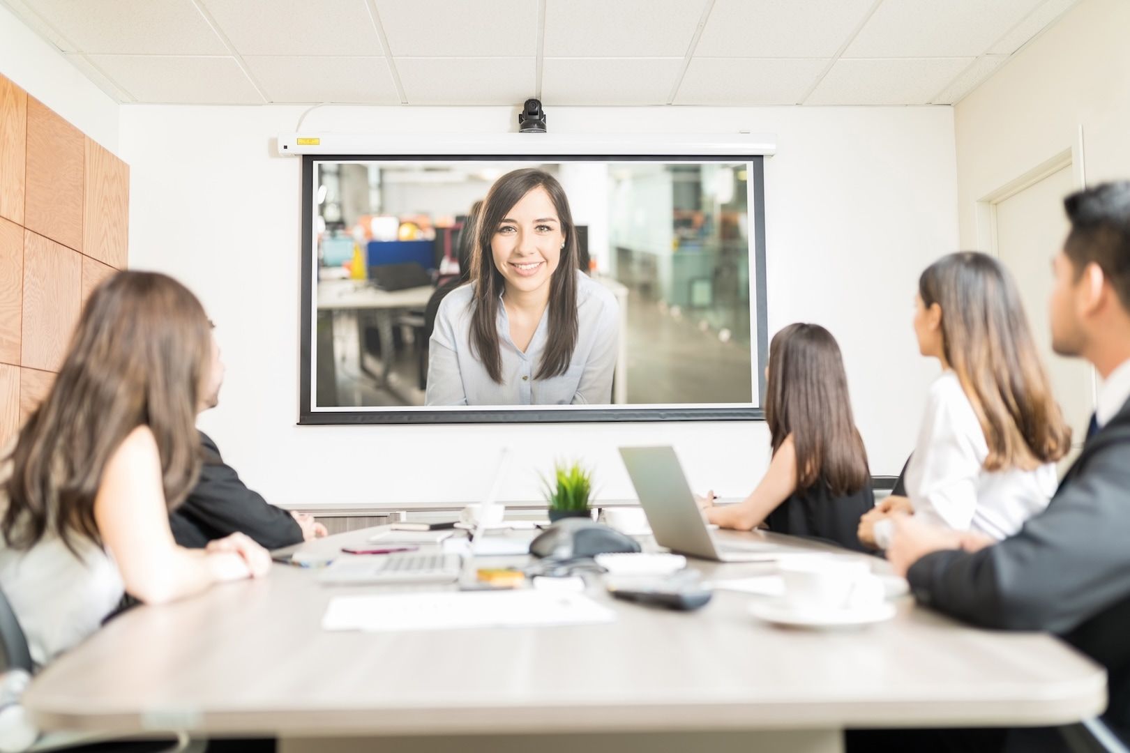 A small team listening to a presentation in a meeting room