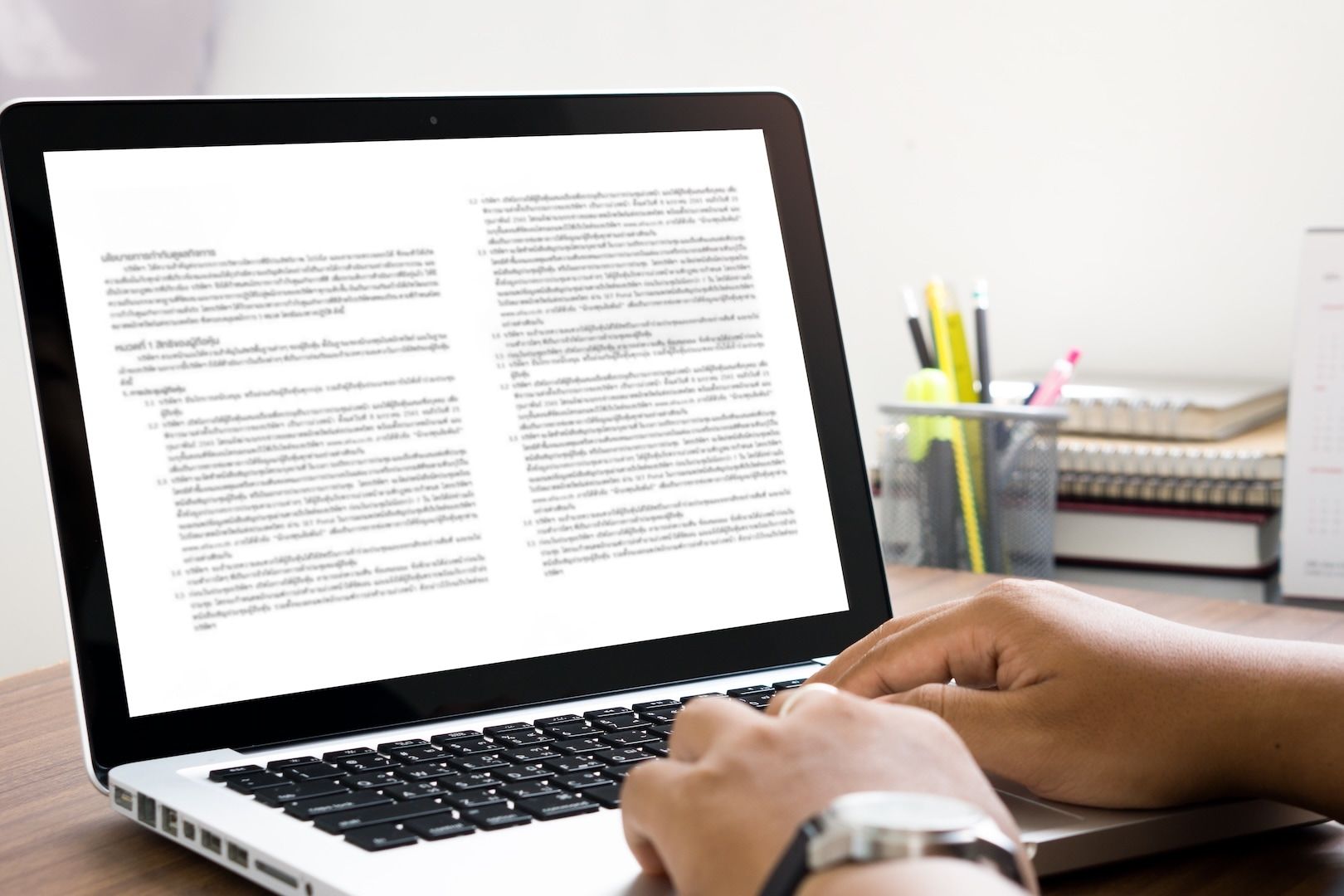 A writer working through notes at a laptop